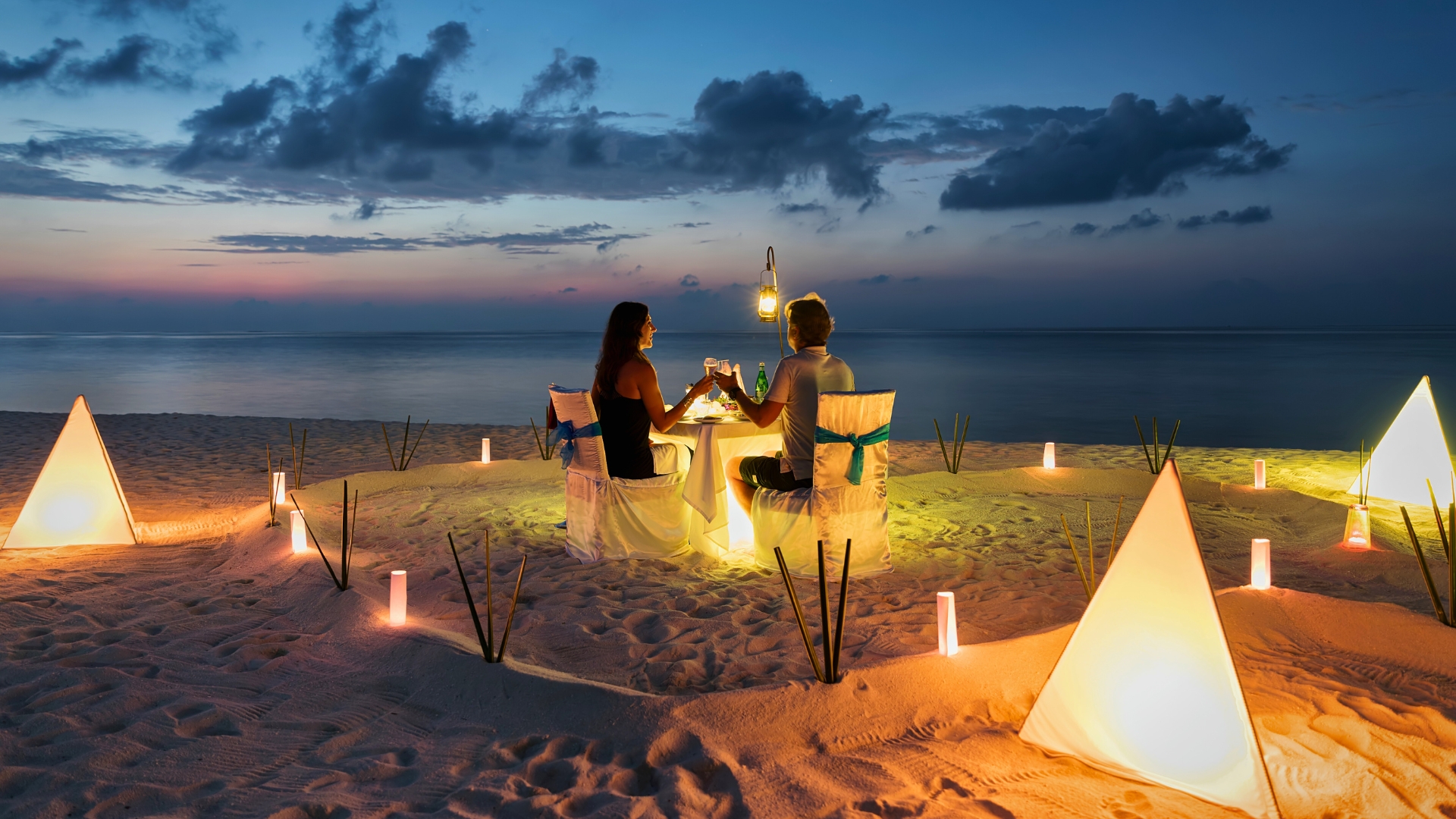 Honeymoon couple is having a private, romantic dinner